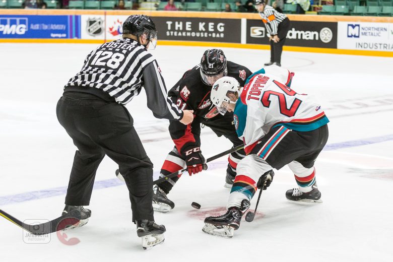 Kyle Topping of the Kelowna Rockets and Connor Bowie of the Prince George Cougars battle for the puck during WHL action in Prince George on Friday night.