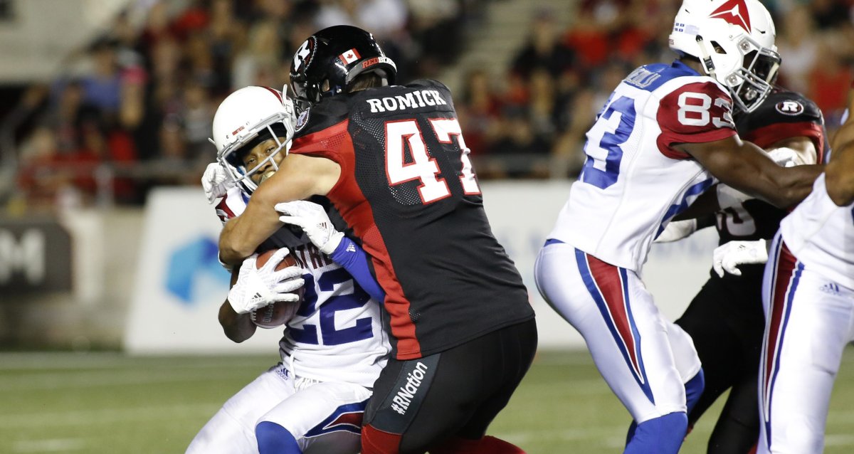 Ottawa Redblacks Nigel Romick (47) tackles Montreal Alouettes Tyquwan Glass (22) during third quarter CFL action in Ottawa on August 11, 2018. Romick signed a one-year extension with the Redblacks on Tuesday.