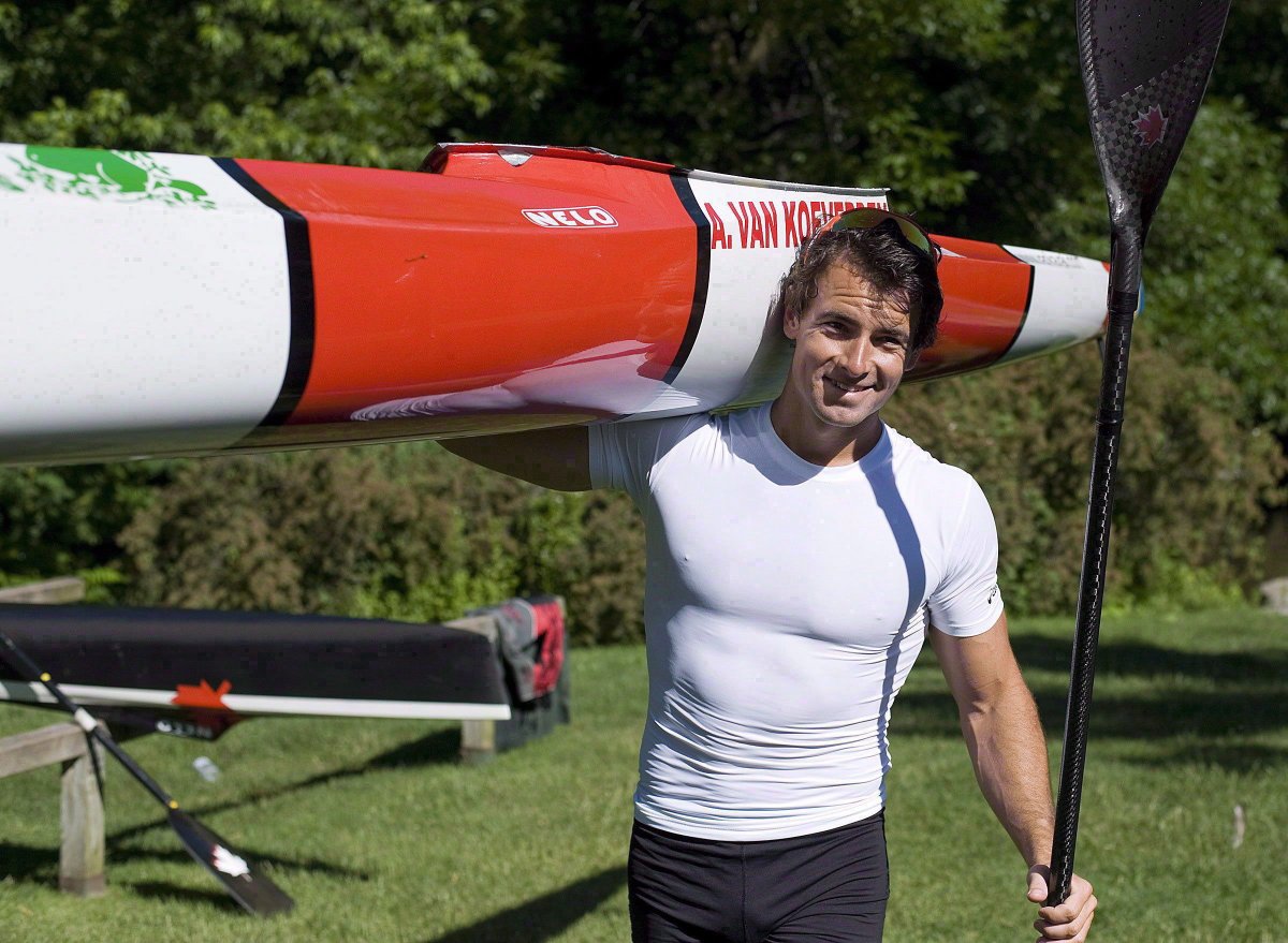 Canadian Olympian Adam van Koeverden carries a kayak at the Burloak Canoe Club in Oakville, Ont. on Wednesday, June 13, 2012.