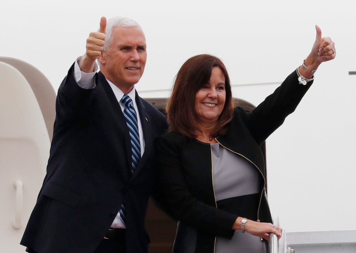 U.S. Vice President Mike Pence and his wife Karen give a thumbs-up as they board Air Force Two at the Yokota U.S. Air Force Base in Fussa, outside Tokyo, Japan, Tuesday, Nov. 13, 2018. 
