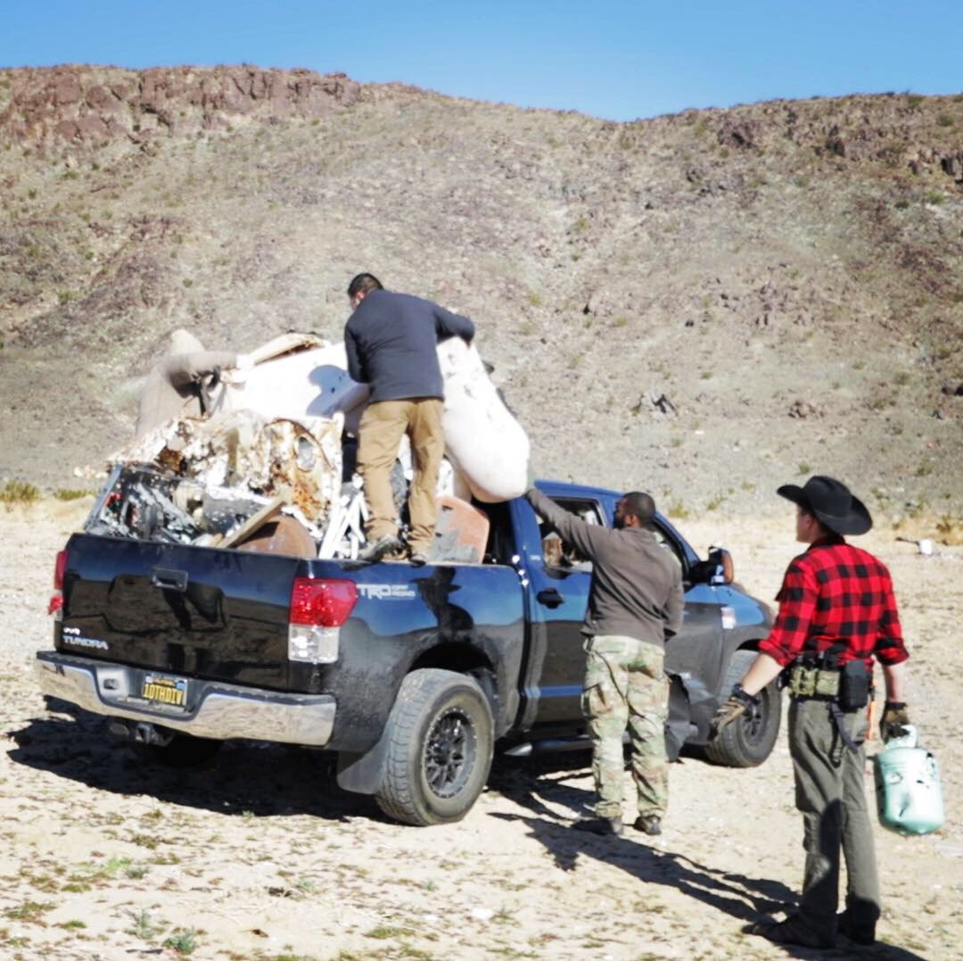 Staff load trash onto a truck near Joshua Tree National Park in California, Jan. 6, 2019, in this picture obtained from social media.