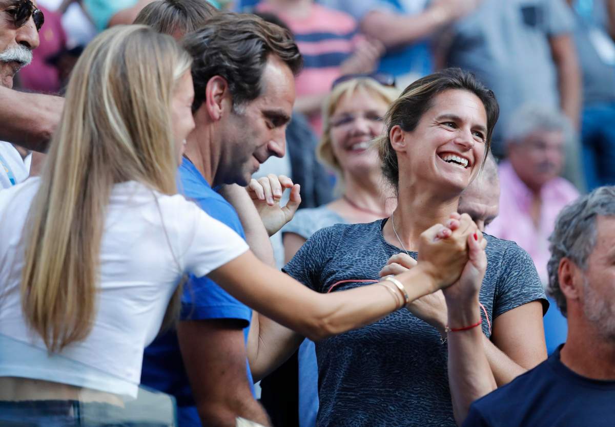 France’s Lucas Pouille coach, Amelie Mauresmo reacts after his match against Canada’s Milos Raonic on January 23, 2019.