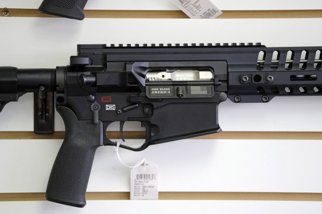 In this Oct. 2, 2018, file photo, a semi-automatic rifle, with "God Bless America" imprinted on it, is displayed for sale on the wall of a gun shop in Lynnwood, Wash. 


