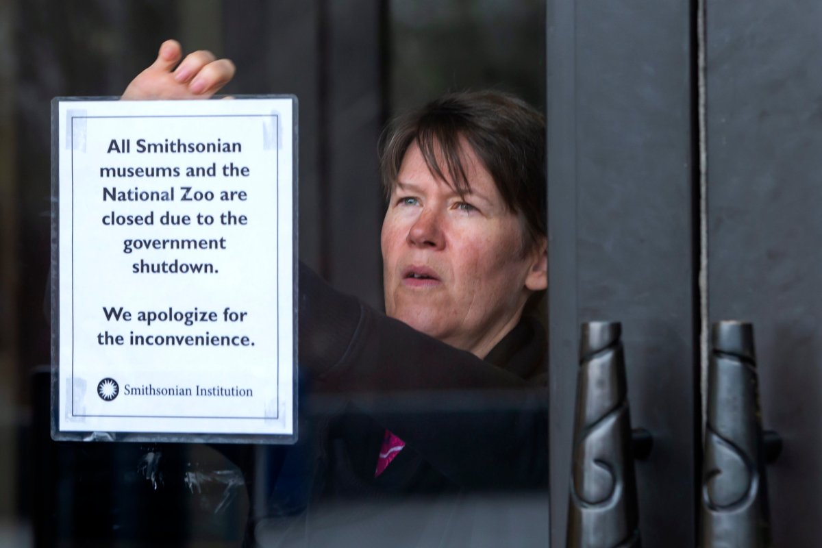 An employee posts a closure sign at the entrance to the Smithsonian American Indian Museum in Washington, D.C., on Jan. 2, 2019. 