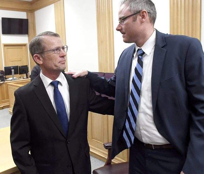 Robert Crosland, left, smiles at his attorney Shane Reichert after he was found not guilty of misdemeanor animal cruelty, Jan. 4, 2019.