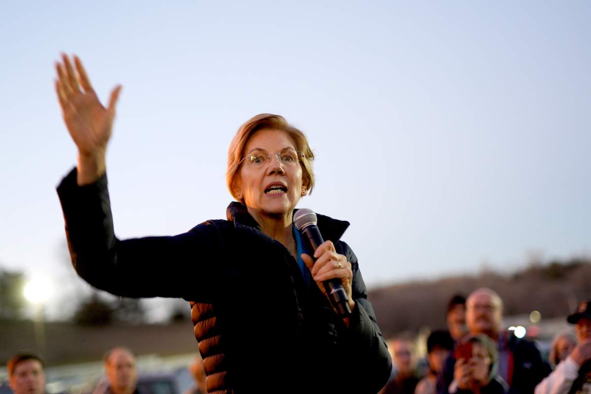 Sen. Elizabeth Warren, D-Mass, addresses an overflow crowd outside an organizing event at McCoy’s Bar Patio and Grill in Council Bluffs, Iowa, Friday, Jan. 4, 2019.