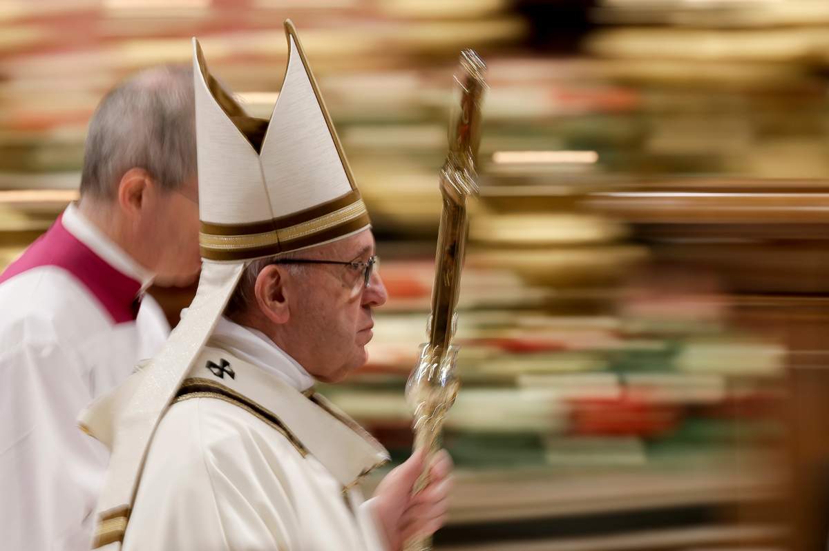 In this photo taken with slow shutter speed Pope Francis leaves after celebrating an Epiphany Mass in St. Peter's Basilica at the Vatican, Sunday, Jan. 6, 2019. 


