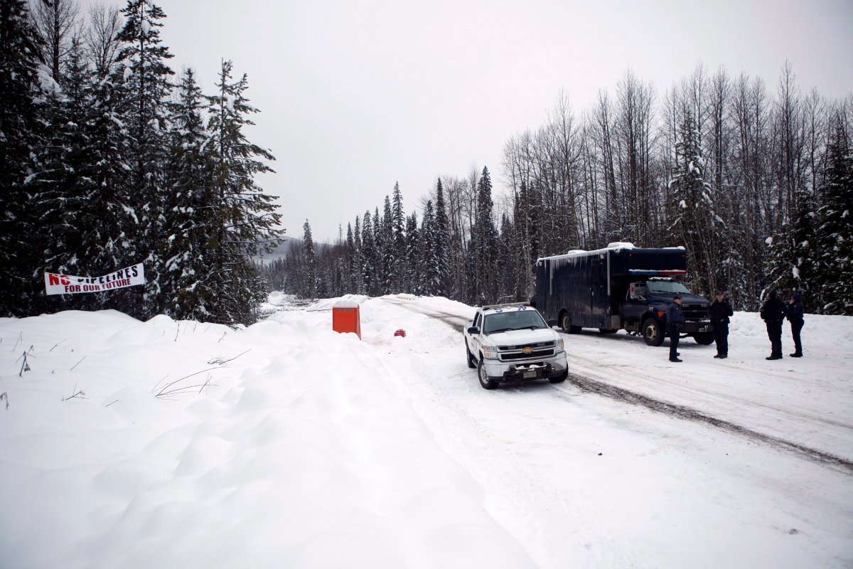 RCMP officers open up the exclusion zone at the Gidimt'en checkpoint at the 44 kilometre marker near the Unist'ot'en Camp south west of Houston, B.C., on Friday, January 11, 2019. 