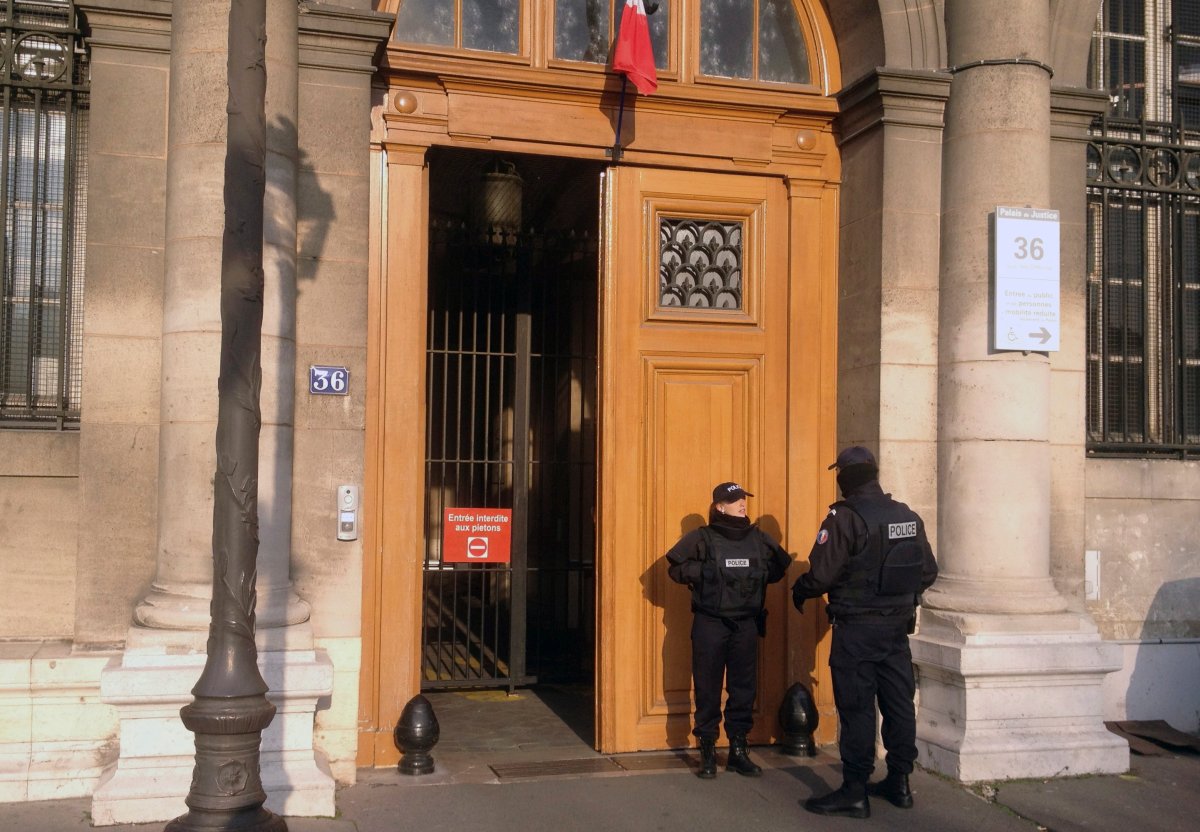 In this Friday, Feb. 6, 2015 file picture, police officers stand guard in front of the 36 Quai des Orfevres police headquarters in Paris, France.