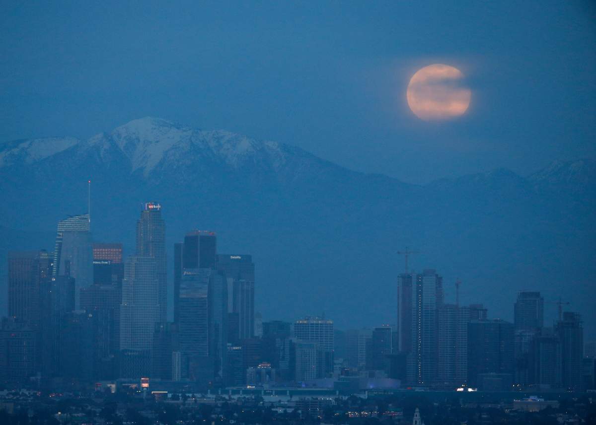 A supermoon rises behind the downtown Los Angeles skyline, as seen from Kenneth Hahn Park in Los Angeles, on Sunday, Jan. 20, 2019.