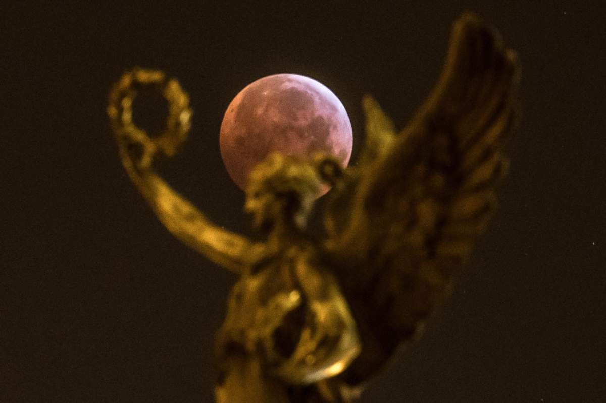 The so-called ‘super blood wolf moon’ is seen over the city centre in Prague, Czech Republic, on Jan. 21, 2019.