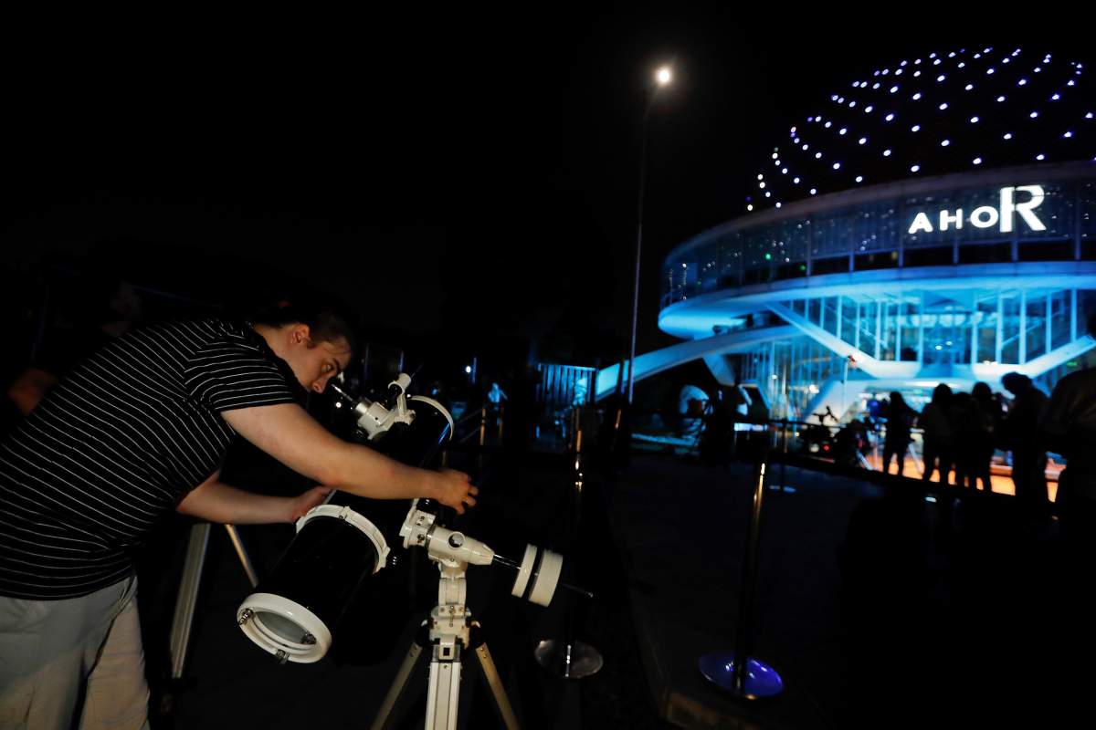 Crowds gather at the planetarium as they wait for the lunar eclipse in Buenos Aires, Argentina, early on Jan. 21, 2019.