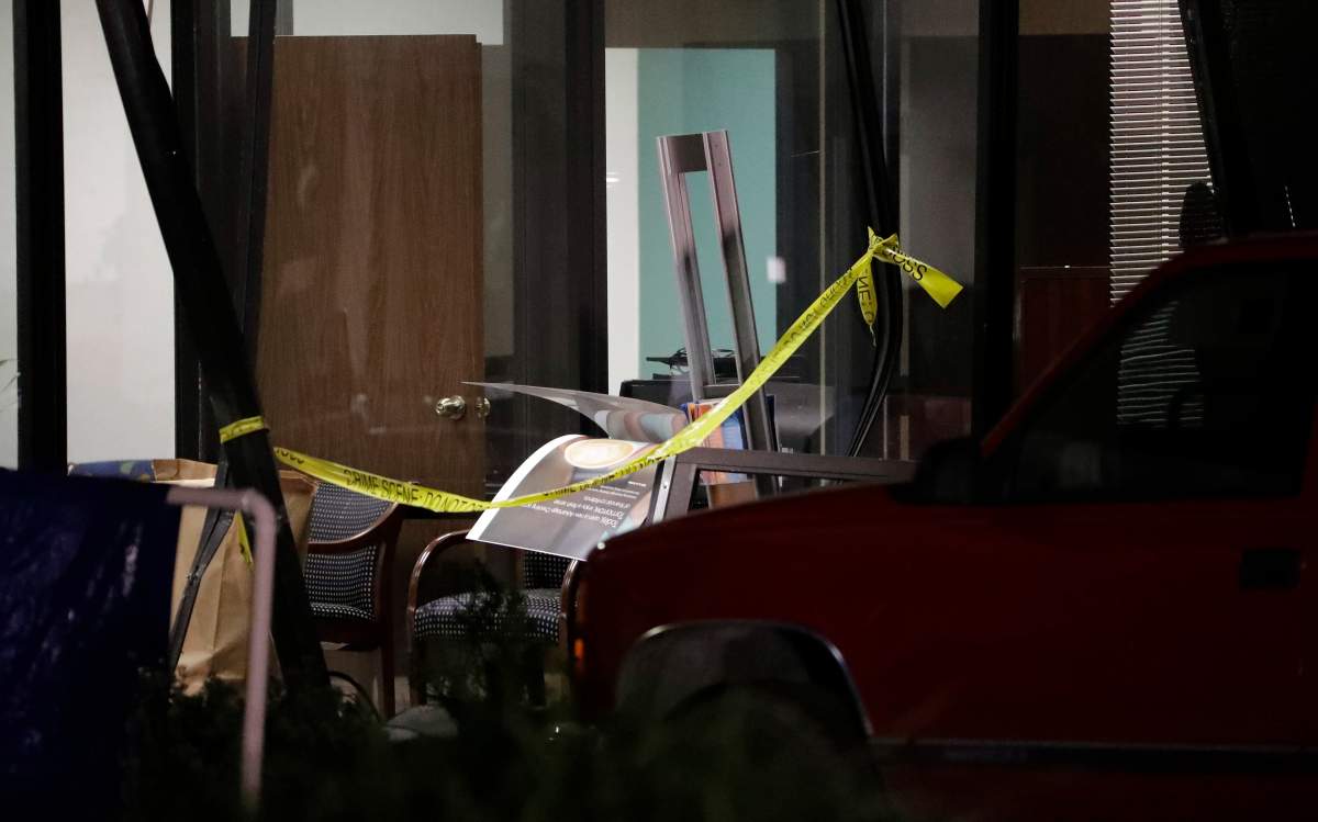 Crime scene tape marks an opening inside the SunTrust bank Thursday, Jan. 24, 2019, in Sebring, Fla. Authorities say five people were shot and killed inside the bank on Wednesday.
