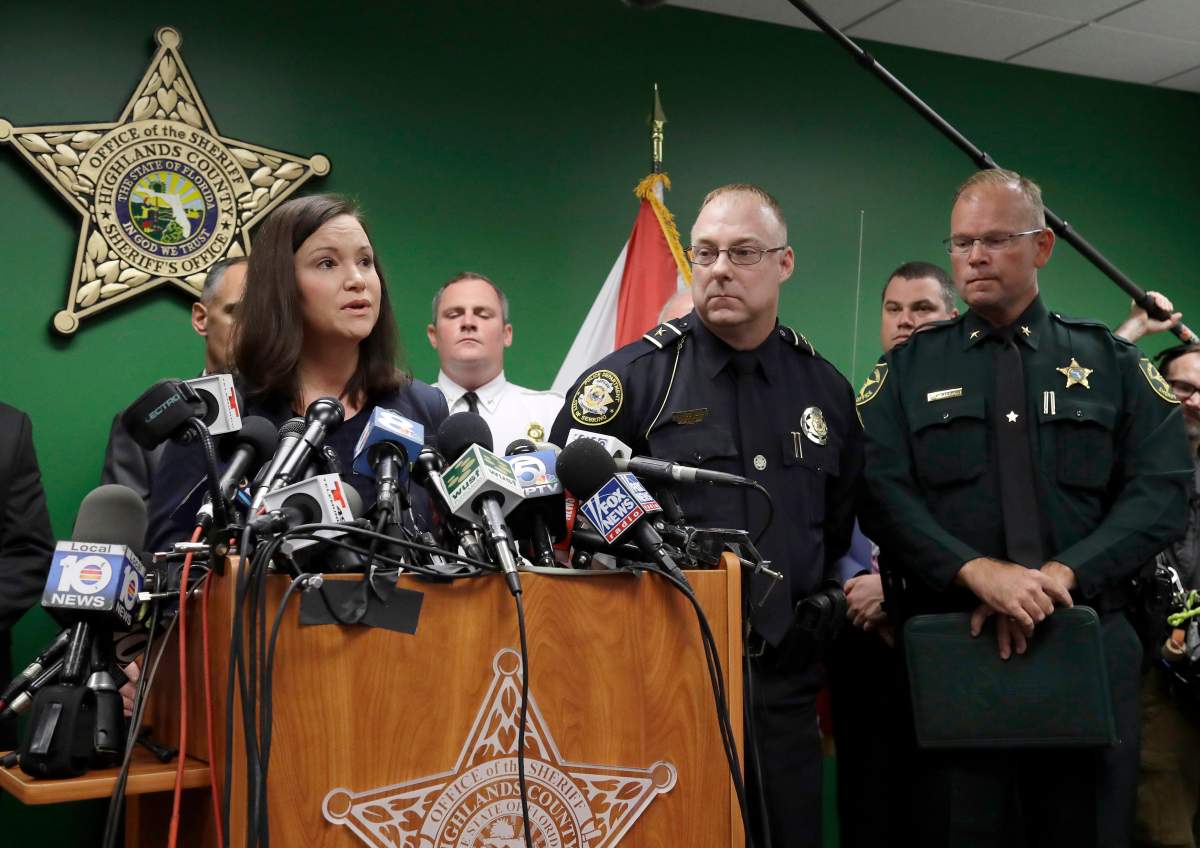 Florida Attorney General Ashley Moody, left, addresses the media as she stands with Sebring Police Chief Karl Hoglund, center, and Highlands County Sheriff Paul Blackman during a news conference, Thursday, Jan. 24, 2019, in Sebring, Fla. 
