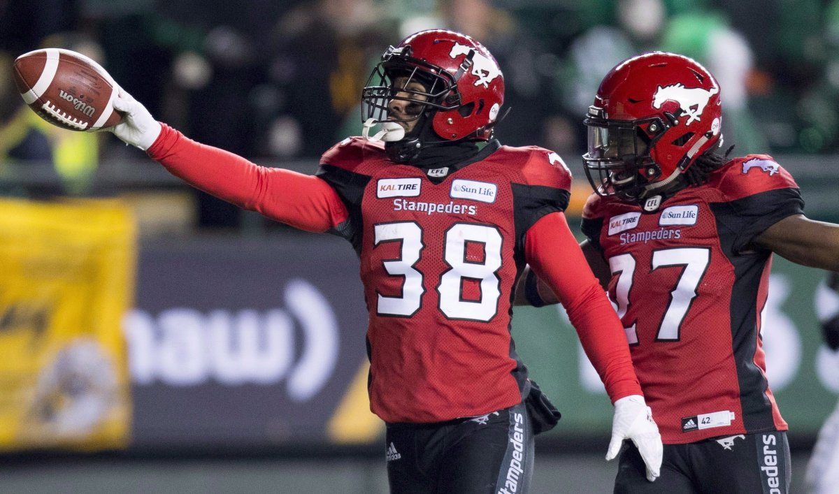 Calgary Stampeders running back Terry Williams (38) celebrates a punt return touchdown against the Ottawa Redblacks with teammate defensive back Tunde Adeleke (27) during the first half of the 106th Grey Cup in Edmonton, Alta. Sunday, Nov. 25, 2018. One of the heroes of the Calgary Stampeders' 2018 Grey Cup win is staying with the CFL team. Terry Williams, who returned a punt 97 yards for a touchdown in the Stamps' Grey Cup victory over the Ottawa Redblacks, re-signed with the team on Friday. 
