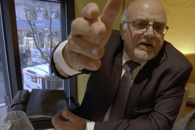 In this image from video, a man who identified himself as Michel Lambert, a director at the Paris-based agricultural technology firm CPW-Consulting, reacts during an interview at a restaurant in New York on Thursday, Jan. 24, 2019.