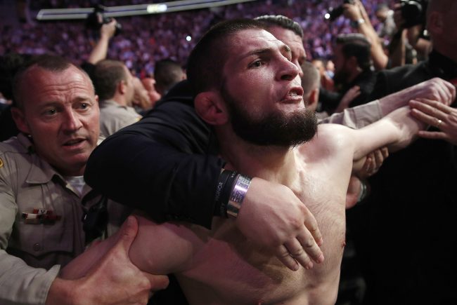 In this Oct. 6, 2018, file photo, Khabib Nurmagomedov is held back outside of the cage after fighting Conor McGregor in a lightweight title mixed martial arts bout at UFC 229 in Las Vegas.