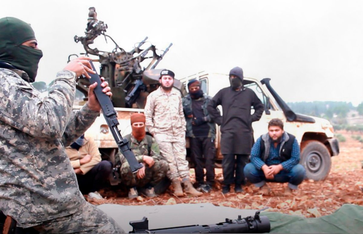 This photo released Tuesday, Nov. 13, 2018 by the al-Qaida-affiliated Ibaa News Agency, shows al-Qaida-linked militants learning how to use a heavy weapon in the countryside of Idlib, Syria. 