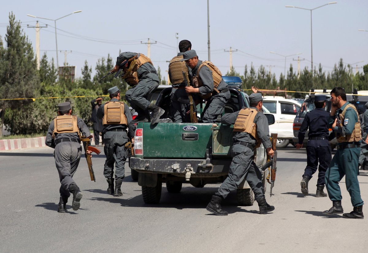 In this May 30, 2018, file photo, Afghan Security personnel arrive at the site of deadly attack on the interior ministry, in Kabul, Afghanistan.