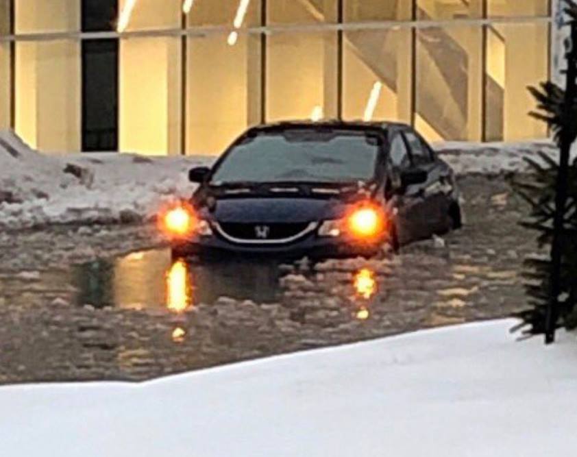 Newfoundland and Labrador cabinet minister Lisa Dempster was rescued from her car after it was stuck on a flooded St. John's street. She says this photo, which was posted on her Facebook page, shows a vehicle that was also trapped near her. She says she was "in a little car further out into deeper water.".