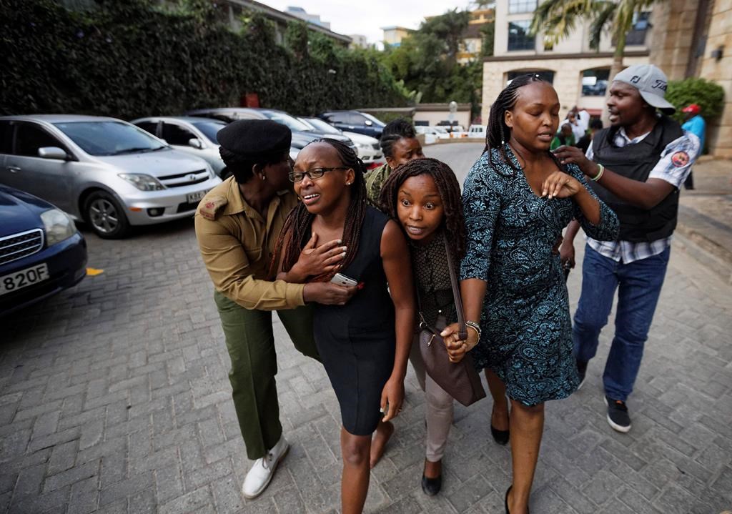 Civilians flee the scene at a hotel complex in Nairobi, Kenya Tuesday, Jan. 15, 2019. 
