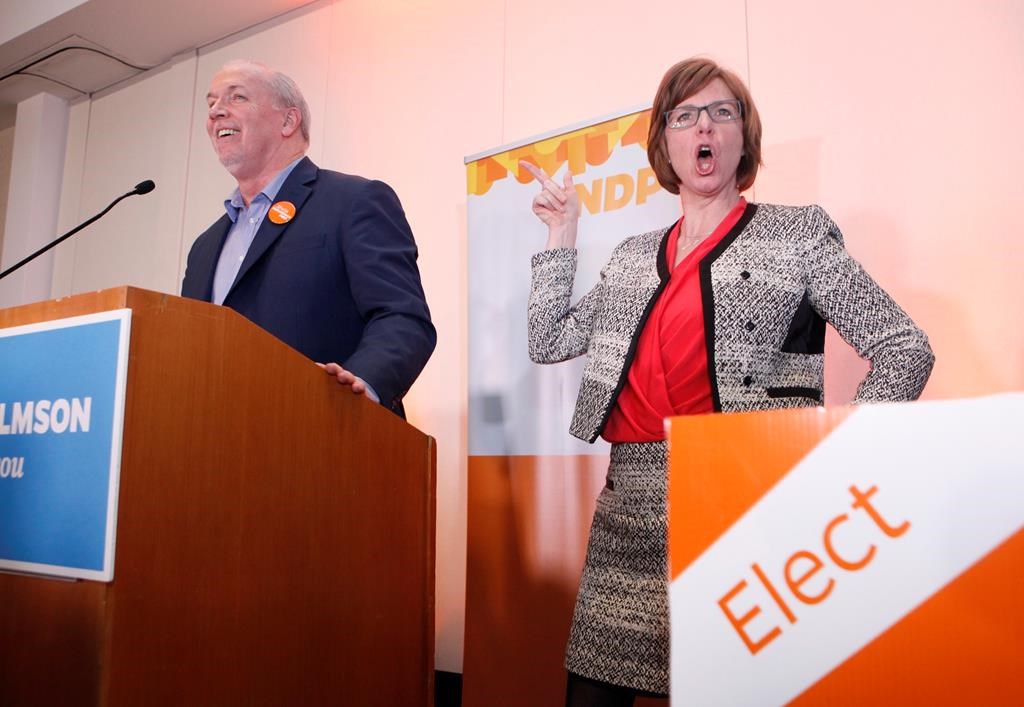 NDP candidate Shiela Malcolmson celebrates with Premier John Horgan after winning the byelection in Nanaimo, B.C., on Wednesday, January 30, 2019. The New Democrats won a key provincial byelection in British Columbia on Wednesday that allows Premier John Horgan's minority government to maintain its grip on power. THE CANADIAN PRESS/Chad Hipolito.