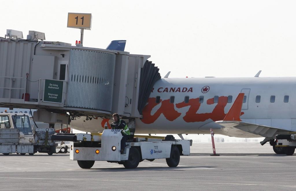 An Air Canada Jazz aircraft sits at a terminal at the Ottawa airport on April 13, 2012.