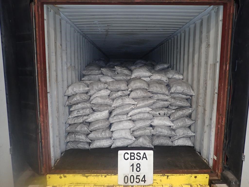 Seized bags of vegetable charcoal that were found to have 33 small packages of cocaine concealed within them are seen in this undated handout photo.