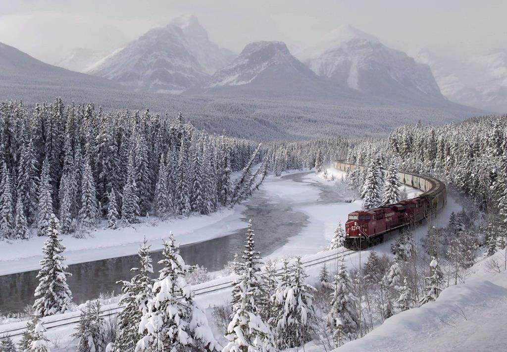 A Canadian Pacific freight train travels around Morant’s Curve near Baker Creek, Alta. on Monday December 1, 2014. Heavy snowfall, warm temperatures and high winds have led to an extreme avalanche risk in Banff, Yoho, Kootenay and Jasper national parks. THE CANADIAN PRESS/Frank Gunn
