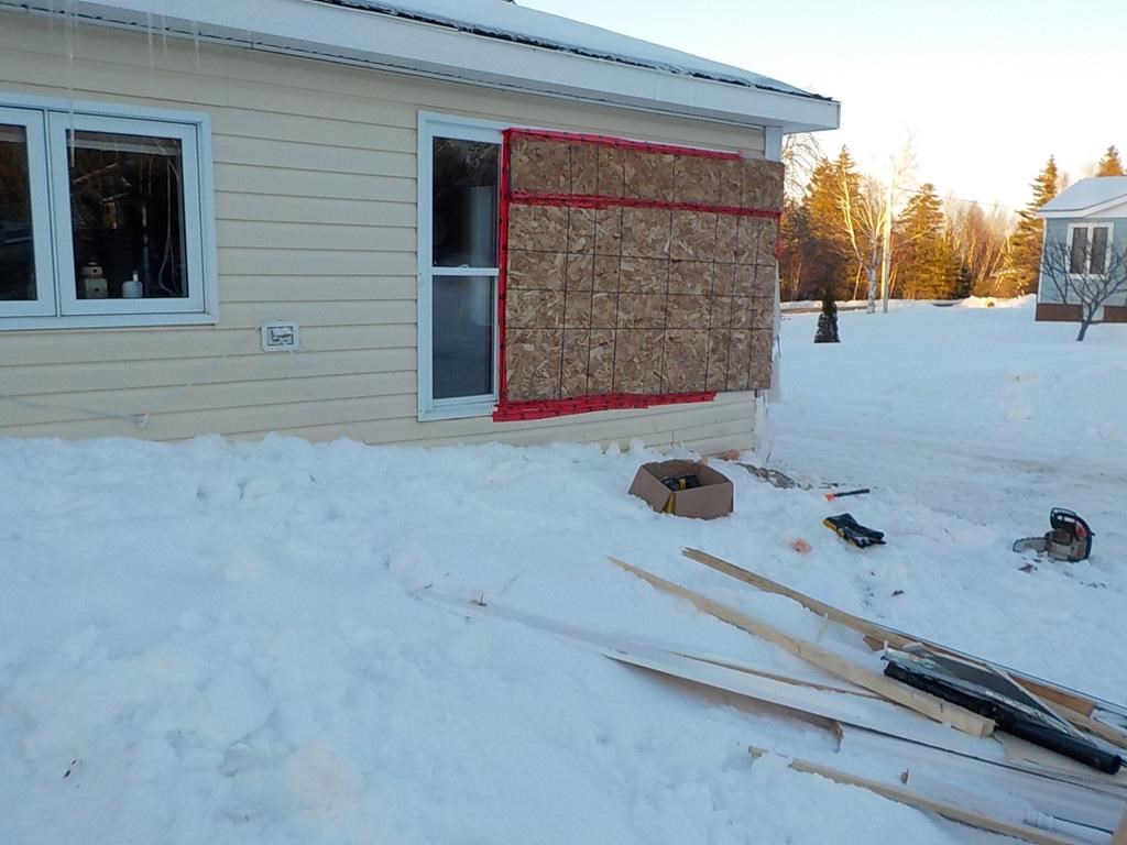 Damage to a home in Porterville, N.L. is seen in this handout photo. A Newfoundland man says it's a miracle his wife is alive after his runaway snowmobile crashed through their home window, smashing furniture and pinning her underneath.