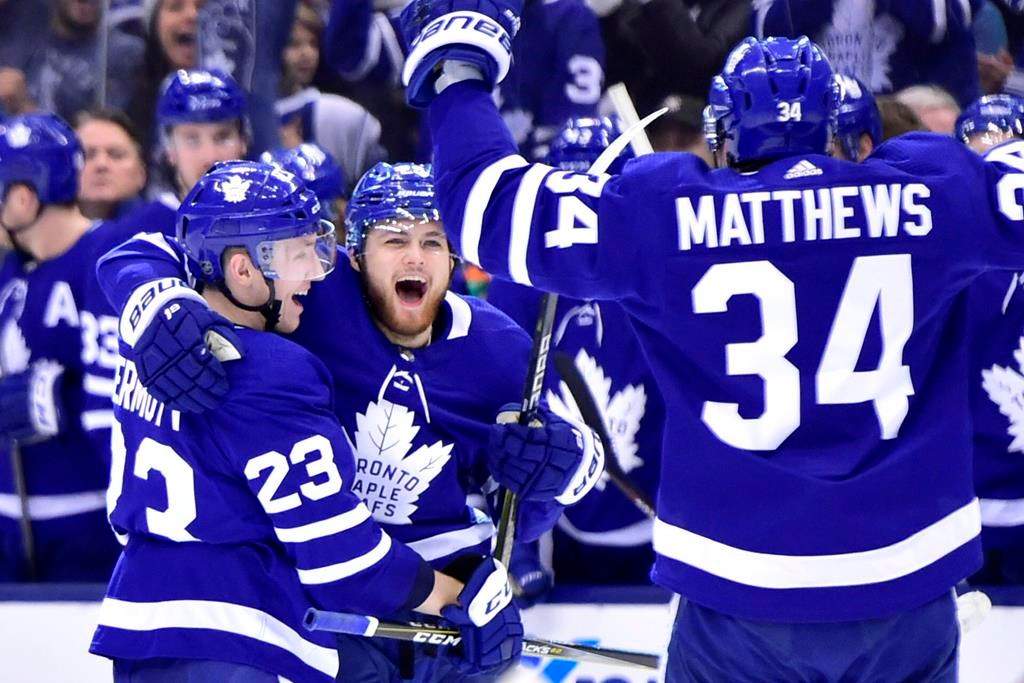Toronto Maple Leafs right wing William Nylander (centre) celebrates his goal against the Minnesota Wild with teammates Travis Dermott (23) and Auston Matthews (34) during second period NHL hockey action in Toronto on Thursday, Jan.3, 2019.