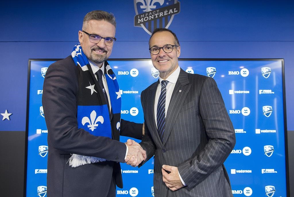 Montreal Impact owner Joey Saputo, right, shakes hands Kevin Gilmore following a news conference in Montreal, Tuesday, January 22, 2019, announcing Gilmore as the new President and CEO of the MLS soccer club.