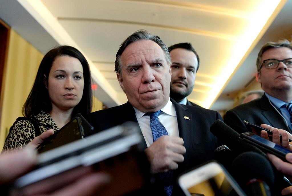 Quebec Premier Francois Legault listens to a questions from reporters before attending a cabinet meeting in Gatineau, Que., on Tuesday, Jan. 29, 2019. The Quebec government has announced it will increase the province's minimum wage but unions believe it's not enough.