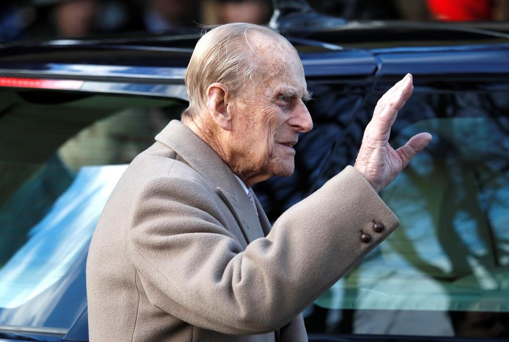 FILE - In this Sunday, Dec. 25, 2016, file photo, Britain's Prince Philip waves to the public as he leaves after attending a Christmas day church service in Sandringham, England.