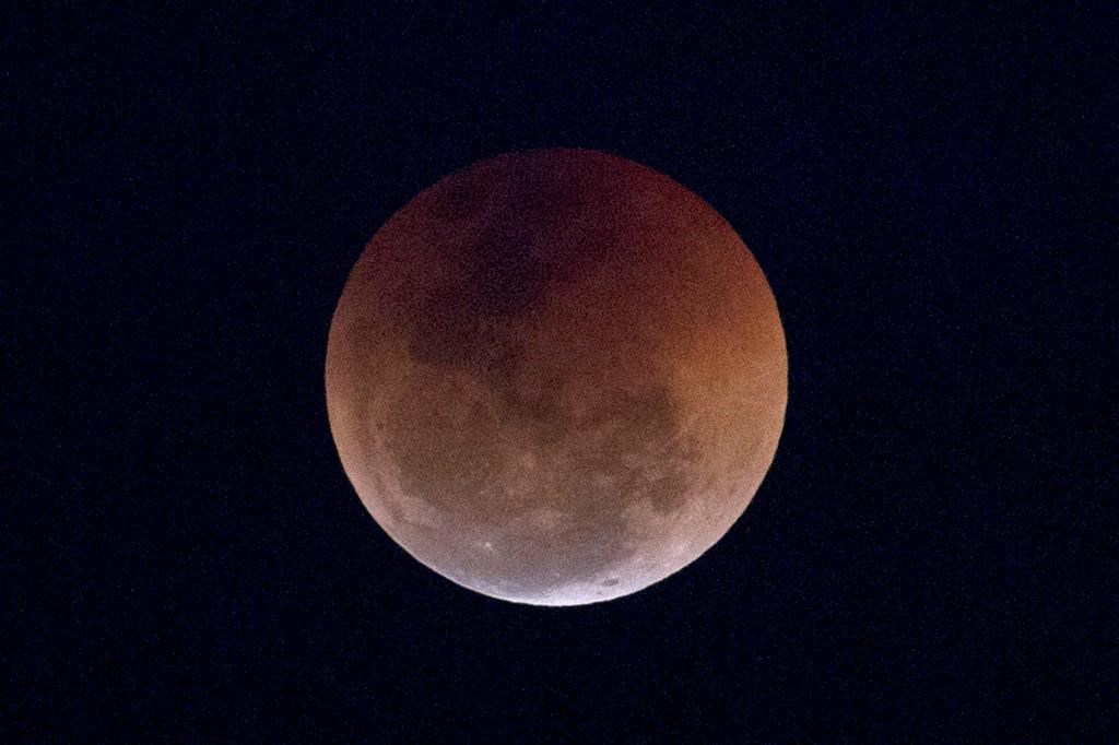This Friday, July 27, 2018 file photo shows a blood moon lunar eclipse from the Arpoador beach in Rio de Janeiro, Brazil.