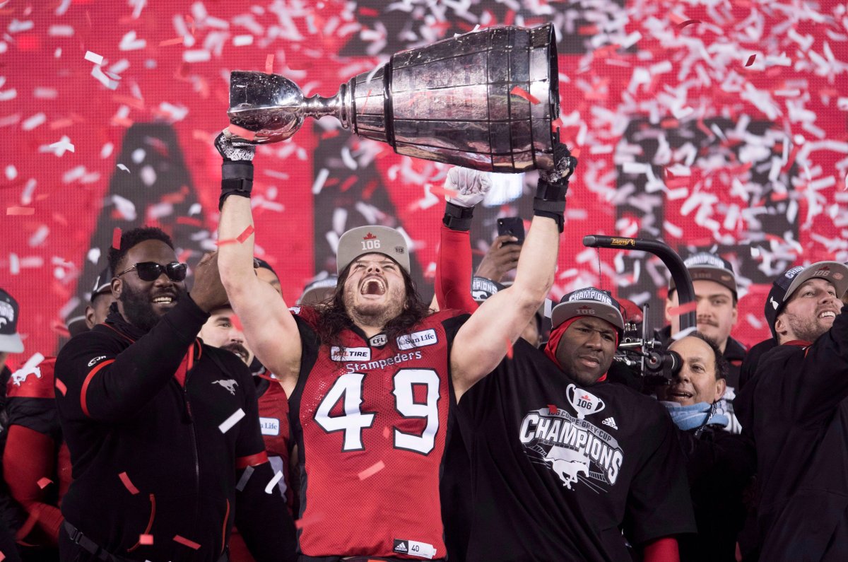 Calgary Stampeders linebacker Alex Singleton (49) hoists the Grey Cup after defeating the Ottawa Redblacks at the 106th Grey Cup in Edmonton, Alta. Sunday, Nov. 25, 2018. 