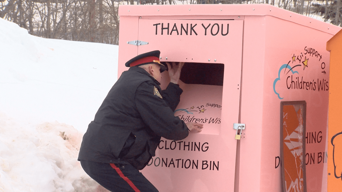 Deputy Chief Brian Cummings shows how the woman could have entered the bin before getting stuck.