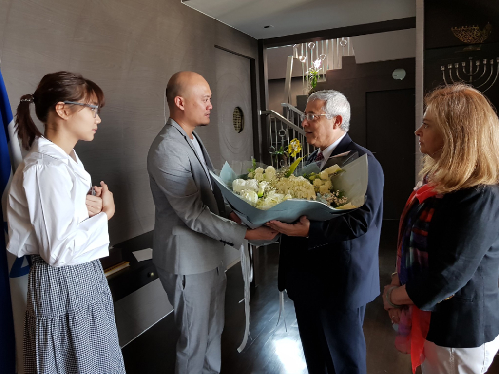 Manager Nataphol Pavaravadhana and singer 'Namsai' of BNK48 with H.E. Ambassador of Israel, Dr. Meir Shlomo on Jan. 27, 2019, after apologizing for wrongly wearing a shirt depicting a swastika onstage. 