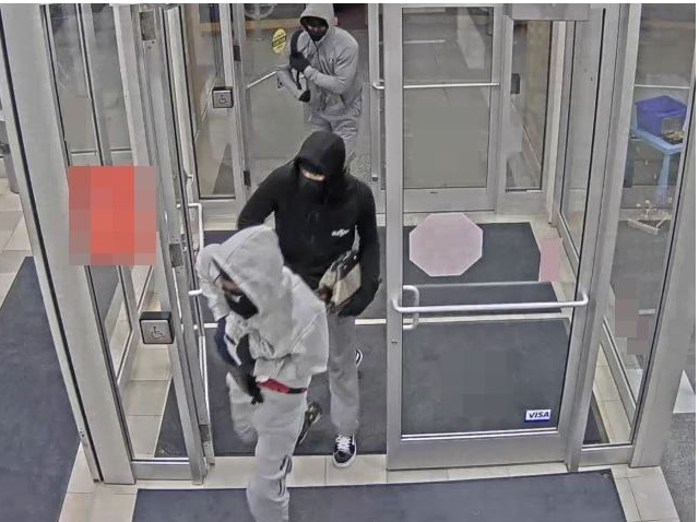 Niagara police are searching for three men after a staff member and customer were held at gunpoint during a St. Catharines bank robbery.