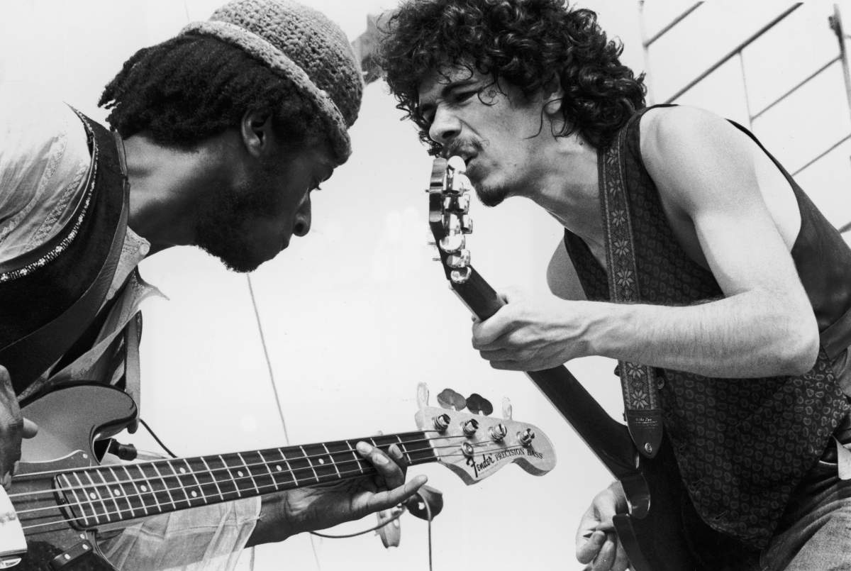 Carlos Santana (R) and bassist David Brown perform with the group Santana at the Woodstock Music Festival on in Bethel, N.Y.