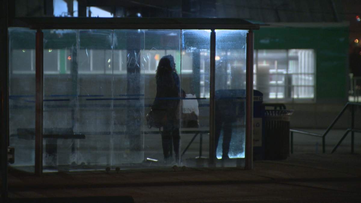 A lone commuter waits for a bus at the Max Bell bus stop.