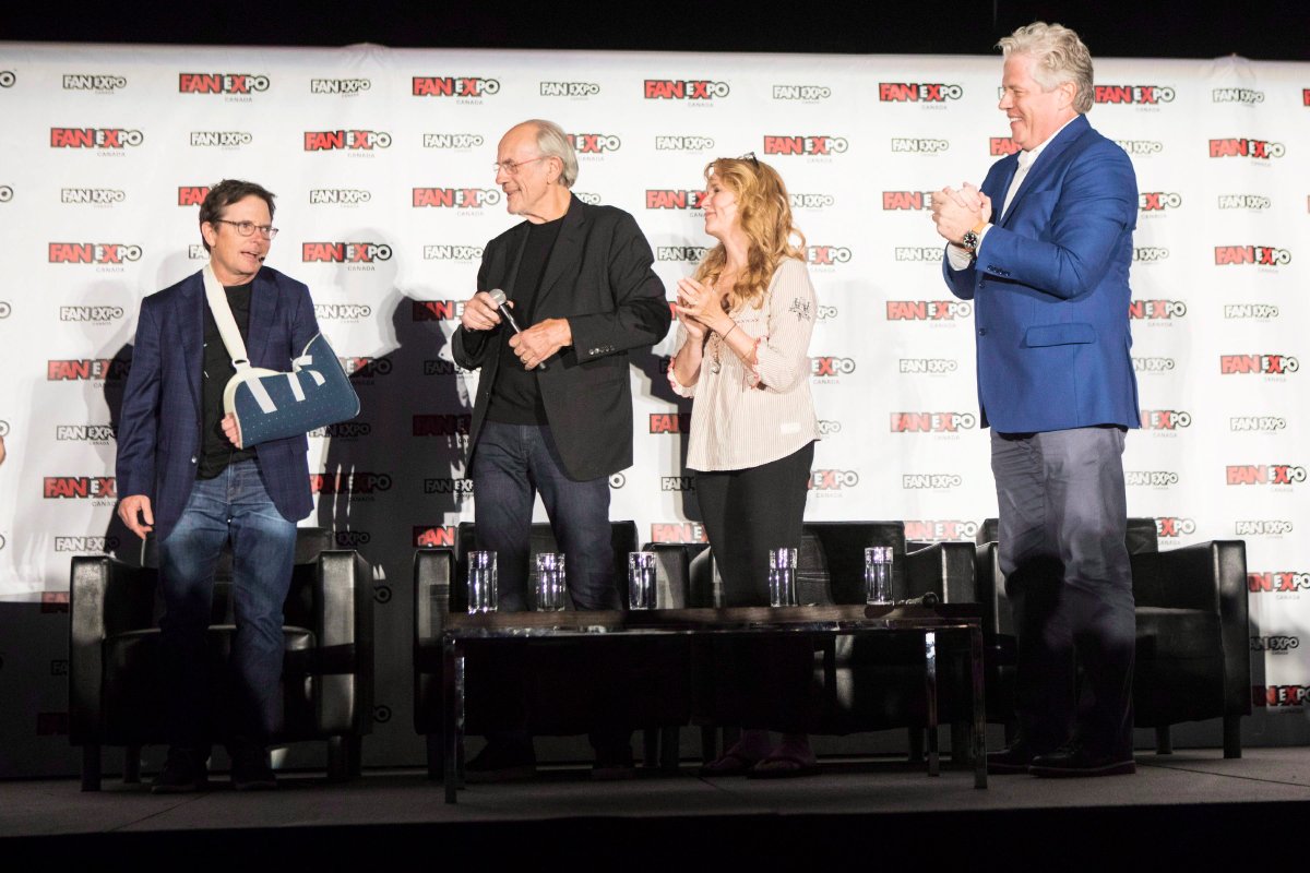 Actor Michael J.Fox (left) is welcomed on stage by fellow cast members Christopher Lloyd (centre left) Lea Thompson (centre right) and Tom Wilson as they attend a panel discussion for the 'Back to the Future' movie franchise at Fan Expo Canada in Toronto on Friday August 31 , 2018. 