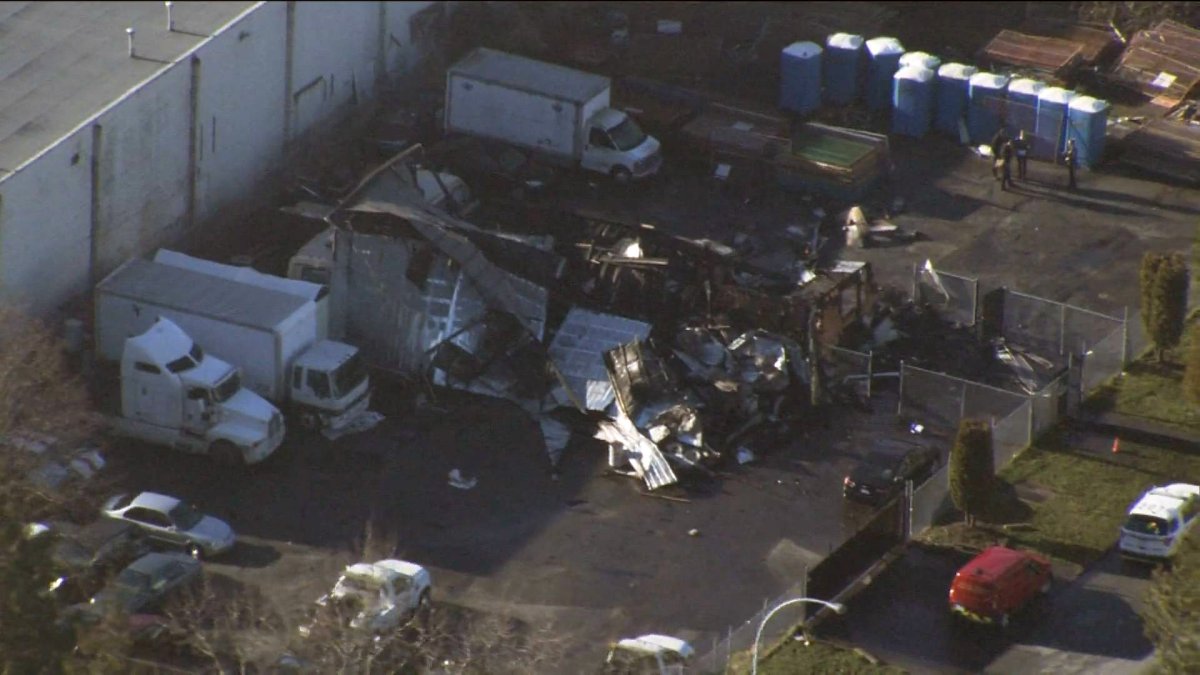 An aerial image shows the completely destroyed structure of H&R Towing.