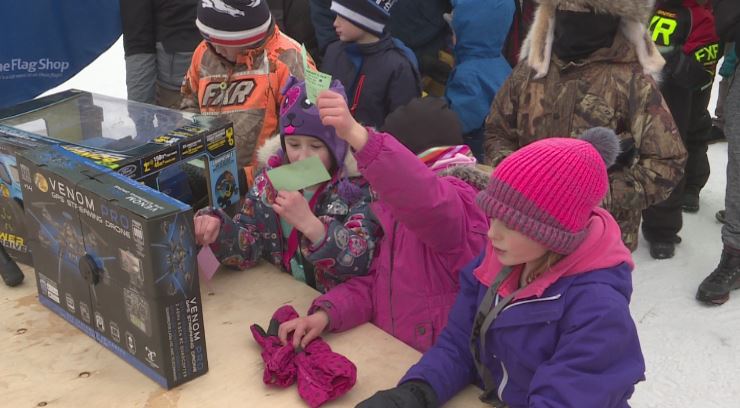 Kids at the 2019 Kid Fish Derby claiming prizes at the main stage.