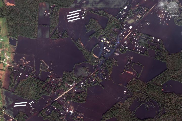 This Sept 20, 2018 satellite image provided by DigitalGlobe shows roads, farms and homes flooded from Hurricane Florence, northeast of Wallace, N.C.