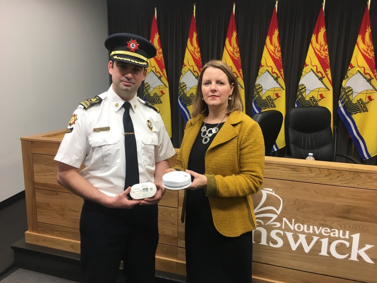 Fredericton Fire Marshall Michael Lewis and Dr. Jennifer Russell demo carbon monoxide alarms. 