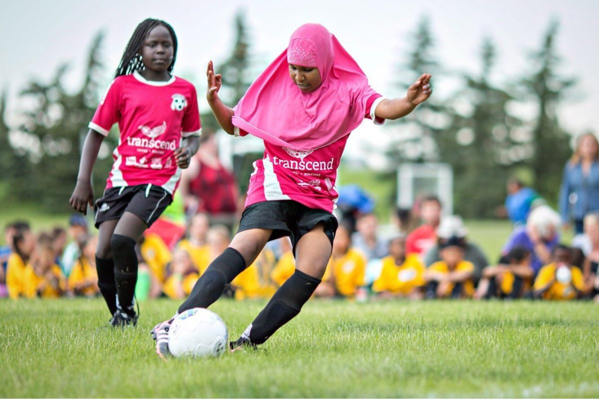 Children in the Free Footie program play soccer during an outdoor tournament in a handout photo.