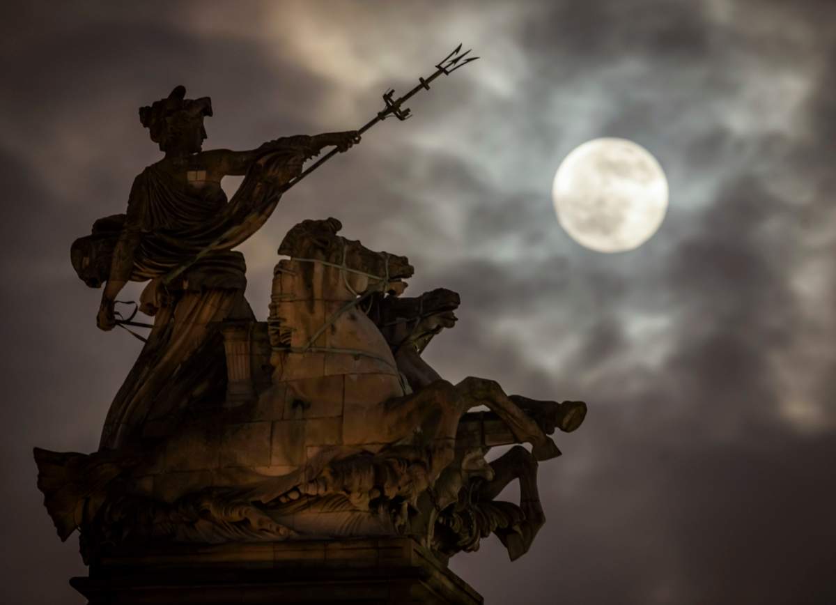 A supermoon rises above the Maritime Prowess statue by Albert Hemstock Hodge at Hull Guildhall, ahead of the lunar eclipse.