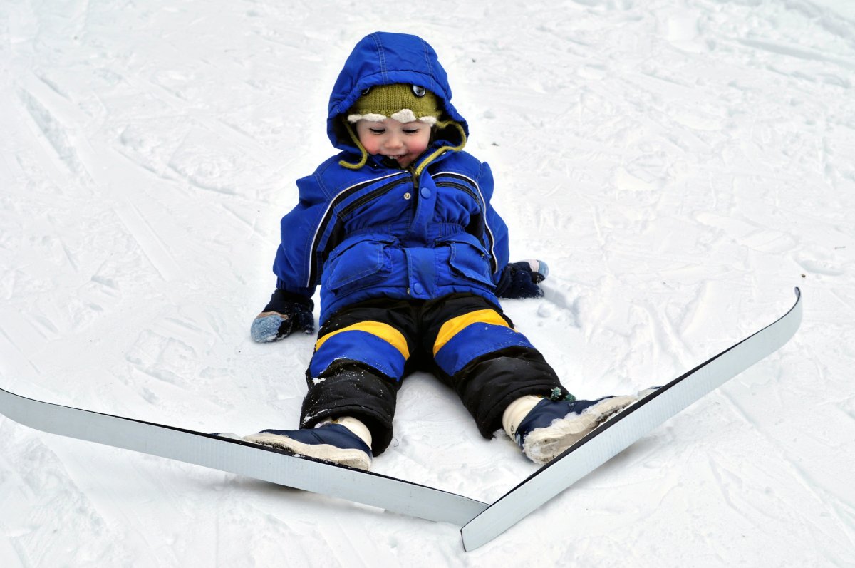 Toddler boy skiing.