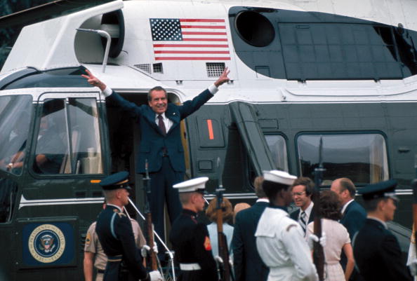 President Richard Nixon shows the victory sign in the doorway of his helicopter after leaving the White House following his resignation over the Watergate scandal, Aug. 9, 1974.